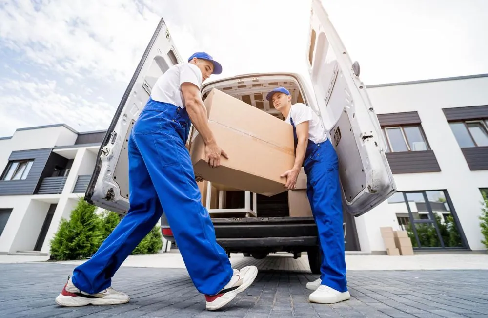 Déménageurs chargeant un carton dans un utilitaire